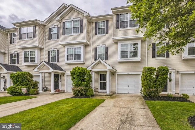 504 Nottingham Pl, Riverside, NJ 08075 - townhome / multi-family property featuring concrete driveway, a front lawn, and a garage