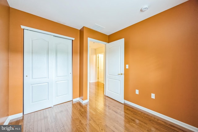 504 Nottingham Pl, Riverside, NJ 08075 - unfurnished bedroom with light wood finished floors, baseboards, and a closet