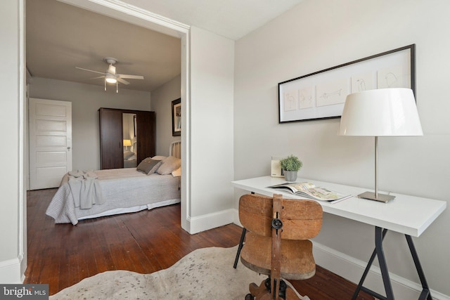 bedroom with baseboards, hardwood / wood-style floors, and a desk