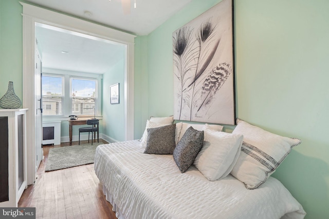 bedroom featuring wood finished floors and baseboards