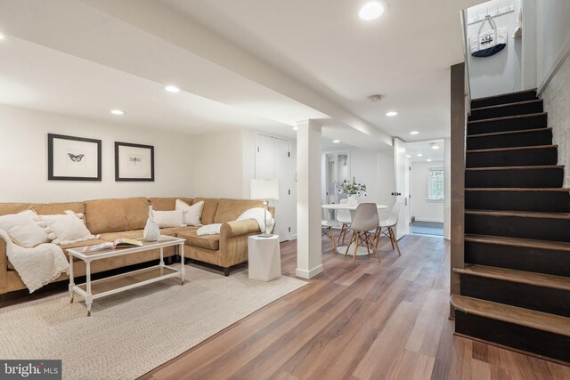 living area featuring stairway, light wood-style flooring, and recessed lighting