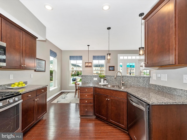 5920 Forum Sq ., Unit Frederick, MD 21703 - kitchen featuring stainless steel appliances, a sink, dark wood-style flooring, light stone counters, and a peninsula