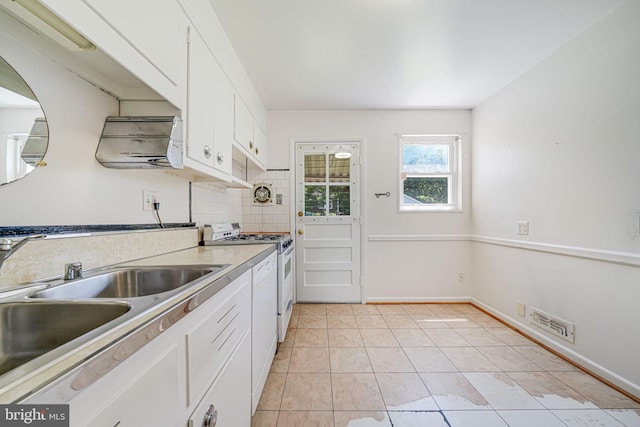 12102 Hunters Ln, Rockville, MD 20852 - kitchen with white appliances, a sink, white cabinets, light tile patterned floors, and light countertops