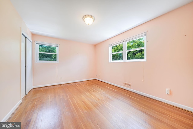 12102 Hunters Ln, Rockville, MD 20852 - unfurnished room featuring light wood finished floors, plenty of natural light, and baseboards