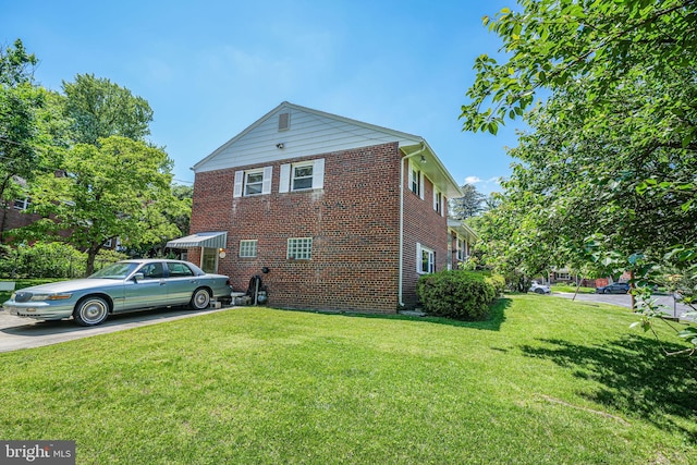 12102 Hunters Ln, Rockville, MD 20852 - view of property exterior featuring a yard, brick siding, and concrete driveway