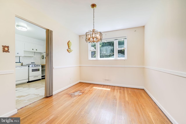 12102 Hunters Ln, Rockville, MD 20852 - spare room with a chandelier, light wood-style flooring, and baseboards
