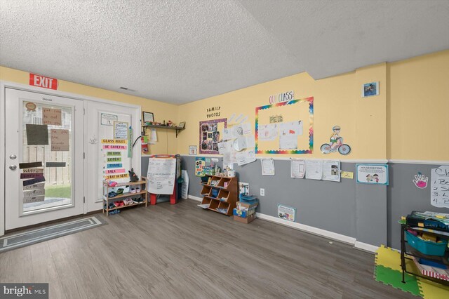 737 Saint Michaels Dr, Bowie, MD 20721 - game room with wood finished floors, a textured ceiling, and baseboards