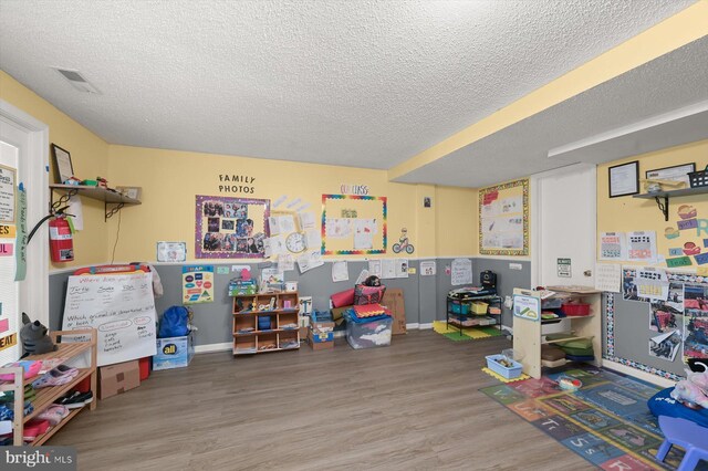 737 Saint Michaels Dr, Bowie, MD 20721 - game room featuring a textured ceiling, wood finished floors, and baseboards