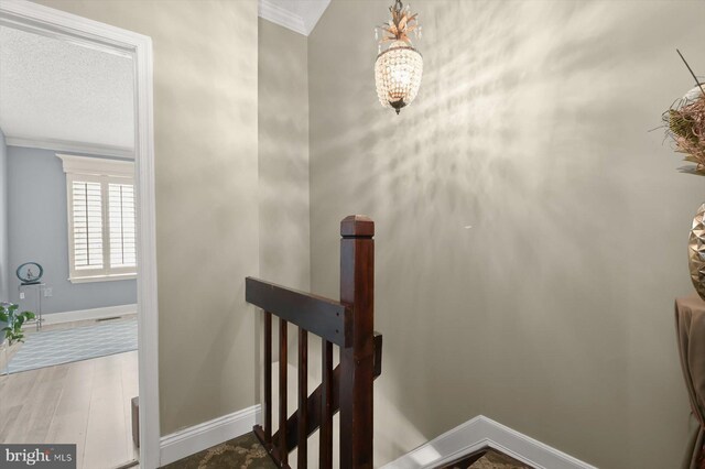 737 Saint Michaels Dr, Bowie, MD 20721 - staircase with crown molding, baseboards, wood finished floors, and a chandelier