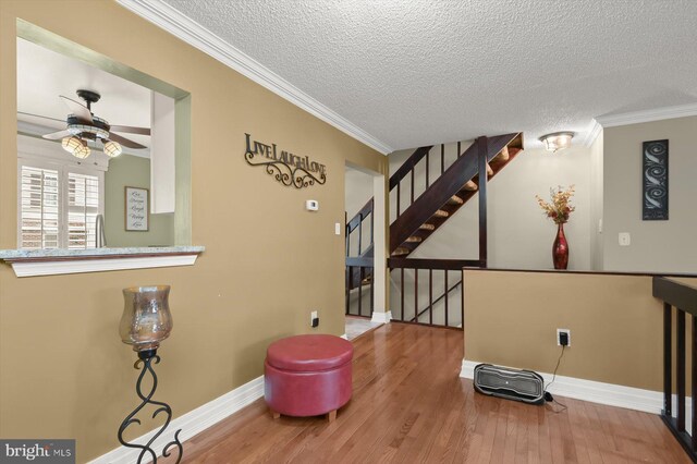737 Saint Michaels Dr, Bowie, MD 20721 - sitting room featuring wood finished floors, a ceiling fan, baseboards, a textured ceiling, and crown molding