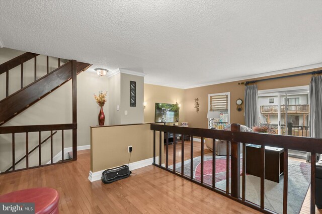 737 Saint Michaels Dr, Bowie, MD 20721 - corridor with wood finished floors, a textured ceiling, crown molding, baseboards, and an upstairs landing