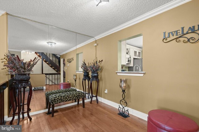 737 Saint Michaels Dr, Bowie, MD 20721 - sitting room featuring a textured ceiling, wood finished floors, stairway, ornamental molding, and baseboards