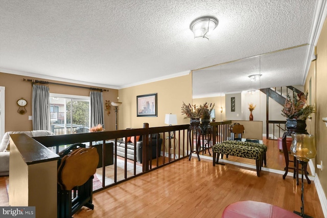 737 Saint Michaels Dr, Bowie, MD 20721 - sitting room featuring wood finished floors, a textured ceiling, ornamental molding, and an upstairs landing