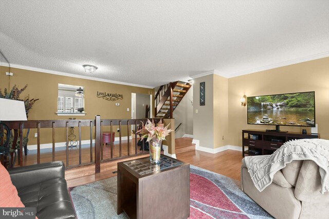 737 Saint Michaels Dr, Bowie, MD 20721 - living area with wood finished floors, crown molding, a textured ceiling, baseboards, and stairway