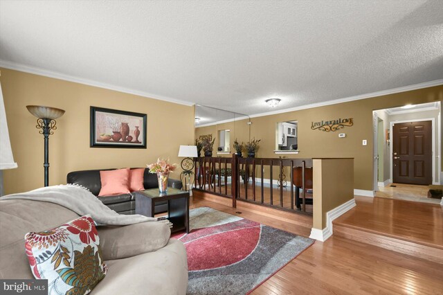737 Saint Michaels Dr, Bowie, MD 20721 - living room with wood finished floors, ornamental molding, a textured ceiling, and baseboards