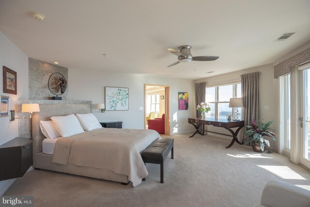 carpeted bedroom with a ceiling fan and access to exterior