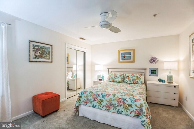 bedroom with carpet flooring, a closet, baseboards, and ceiling fan