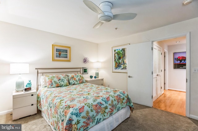 carpeted bedroom with a ceiling fan and baseboards