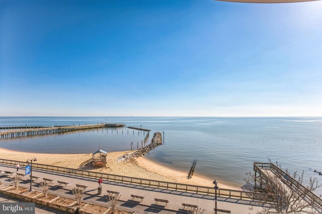 dock featuring a water view and fence