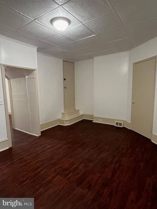 4714 Woodland Ave, Philadelphia, PA 19143 - finished basement with dark wood-style floors, a paneled ceiling, and baseboards