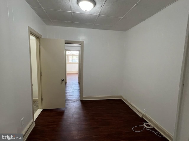4714 Woodland Ave, Philadelphia, PA 19143 - unfurnished room featuring dark wood finished floors, a paneled ceiling, and baseboards
