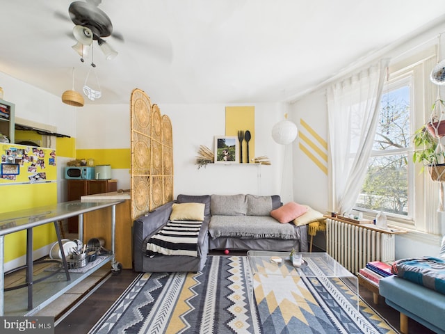 4714 Woodland Ave, Philadelphia, PA 19143 - living room featuring a ceiling fan, radiator, and wood finished floors
