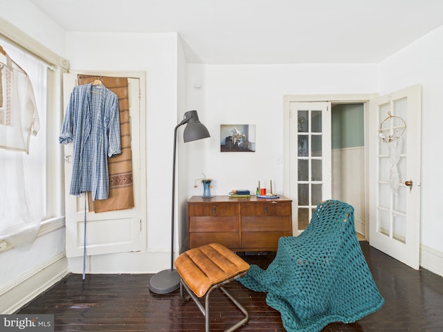 4714 Woodland Ave, Philadelphia, PA 19143 - sitting room with wood finished floors, baseboards, and french doors