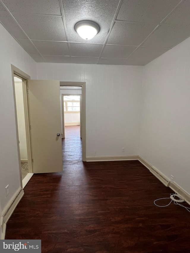 4714 Woodland Ave, Philadelphia, PA 19143 - spare room with wood finished floors, a baseboard heating unit, and baseboards