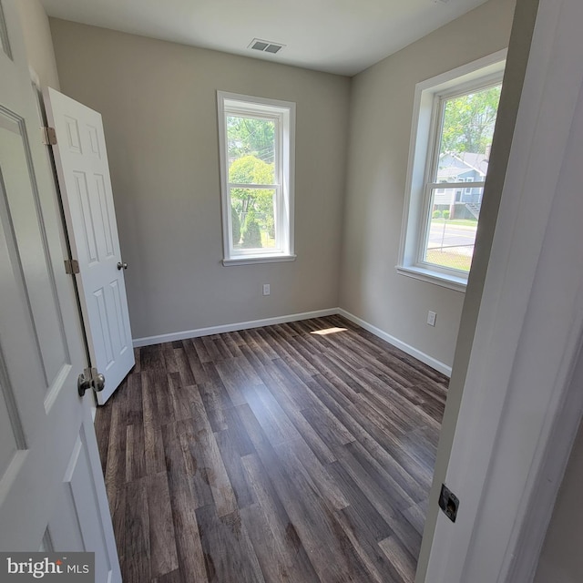 4105 38th St, Brentwood, MD 20722 - unfurnished bedroom featuring multiple windows, dark wood-style flooring, and baseboards