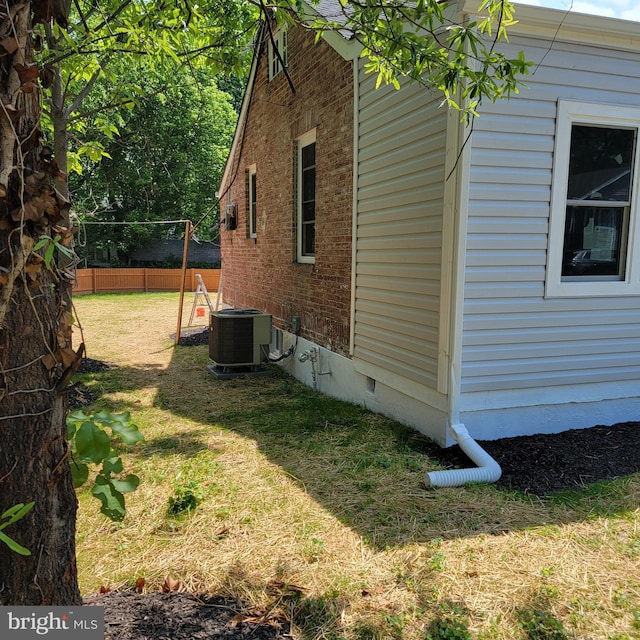 4105 38th St, Brentwood, MD 20722 - view of property exterior featuring crawl space, brick siding, and central air condition unit
