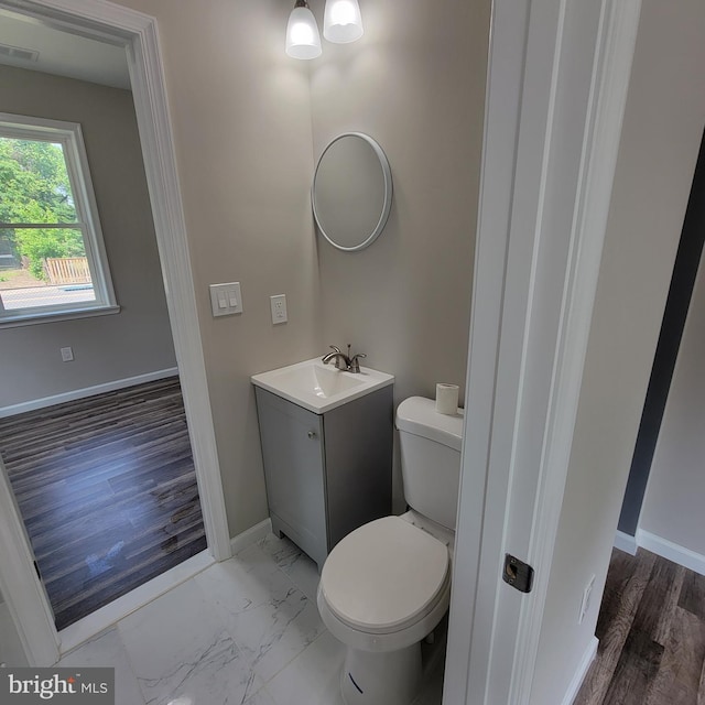 4105 38th St, Brentwood, MD 20722 - bathroom with vanity, toilet, baseboards, and marble finish floors