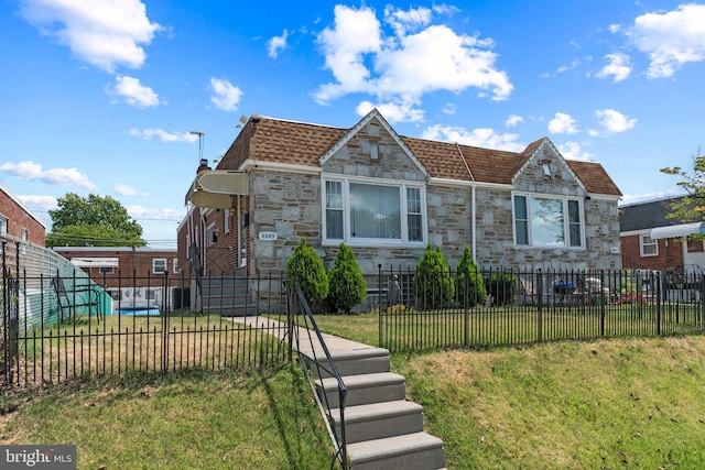 view of front of house featuring stone siding and a shingled roof