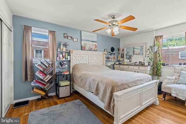 bedroom featuring wood finished floors, a closet, and a ceiling fan