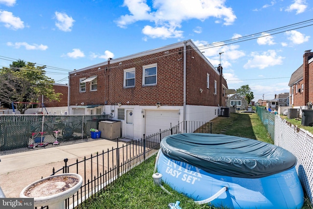 view of property exterior with driveway, a garage, cooling unit, and a residential view