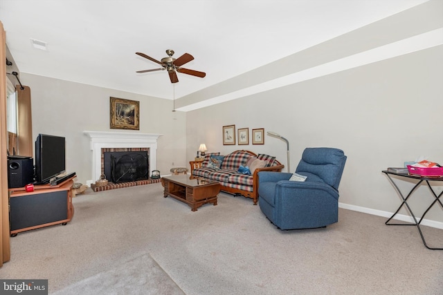 living area featuring carpet, ceiling fan, a brick fireplace, and baseboards