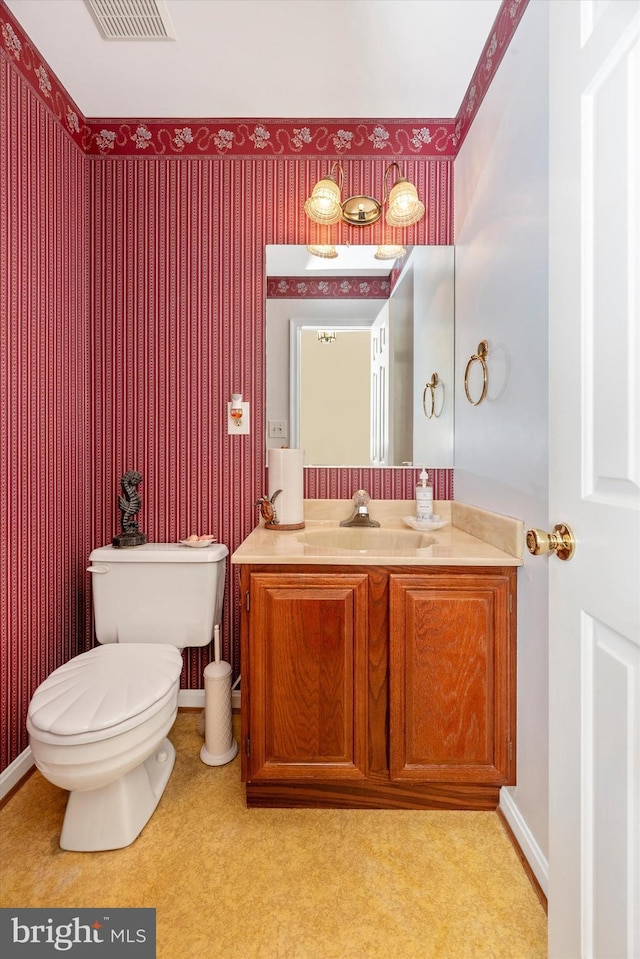 half bathroom with toilet and vanity