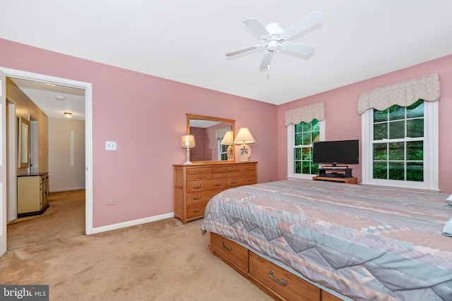 bedroom with light carpet, baseboards, and ceiling fan