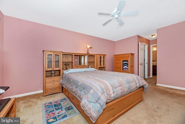 bedroom featuring light colored carpet, baseboards, and a ceiling fan