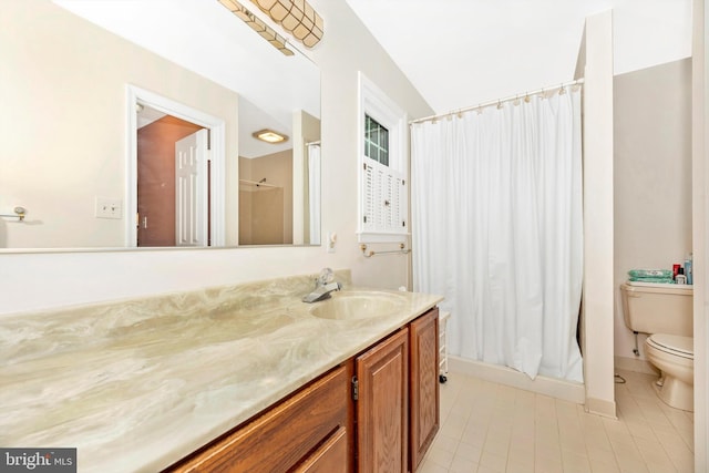 full bath with tile patterned floors, toilet, vanity, and curtained shower