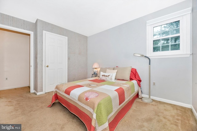 bedroom featuring carpet, baseboards, and wallpapered walls