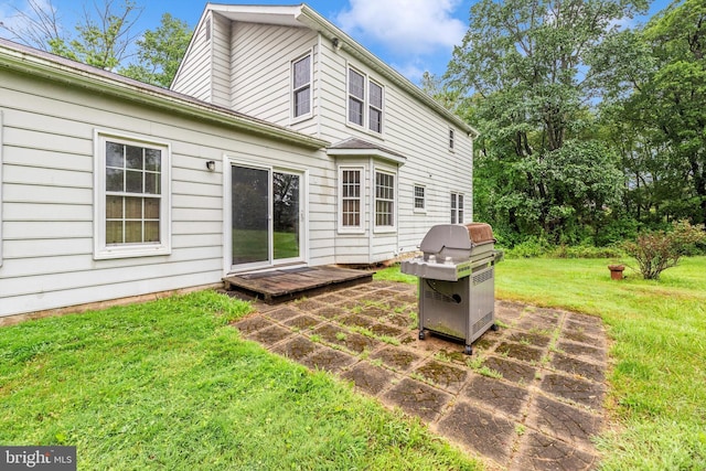 back of house featuring a yard and a patio area