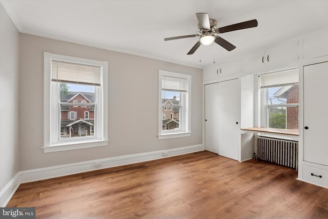 116 N 9th St, Perkasie, PA 18944 - unfurnished bedroom with radiator heating unit, multiple windows, wood finished floors, and ornamental molding