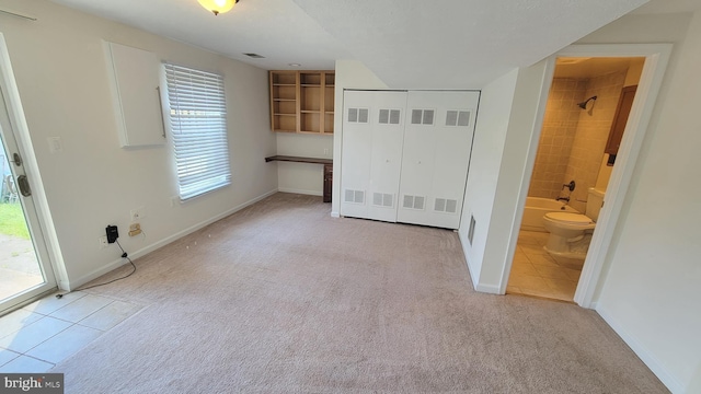 19503 Fetlock Dr, Germantown, MD 20874 - unfurnished bedroom featuring light colored carpet, light tile patterned flooring, baseboards, and connected bathroom