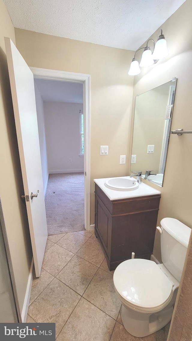 19503 Fetlock Dr, Germantown, MD 20874 - half bath with vanity, a textured ceiling, toilet, tile patterned floors, and baseboards