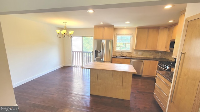 19503 Fetlock Dr, Germantown, MD 20874 - kitchen featuring stainless steel appliances, light brown cabinetry, a sink, a chandelier, and baseboards