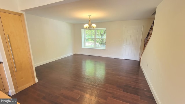 19503 Fetlock Dr, Germantown, MD 20874 - empty room with a chandelier, dark wood-style flooring, stairway, and baseboards
