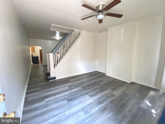 433 E Auburn St, Philadelphia, PA 19134 - unfurnished living room with arched walkways, stairs, ceiling fan, and dark wood finished floors