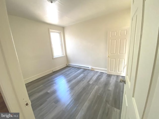 433 E Auburn St, Philadelphia, PA 19134 - empty room featuring a baseboard heating unit, dark wood finished floors, and baseboards