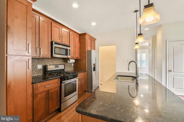 1910 Scaffold Way, Odenton, MD 21113 - kitchen featuring appliances with stainless steel finishes, a sink, decorative backsplash, brown cabinets, and dark stone countertops