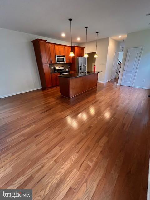 1910 Scaffold Way, Odenton, MD 21113 - kitchen with stainless steel appliances, dark countertops, open floor plan, dark wood-style floors, and recessed lighting